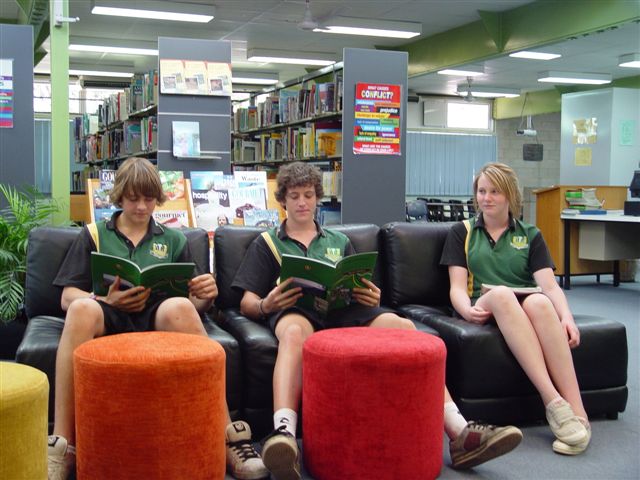 students on coach reading in resource centre